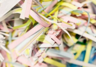 Pile of shredded paper in various colours that will have been sourced responsibly as part of the rise of sustainable practices in the printing industry.